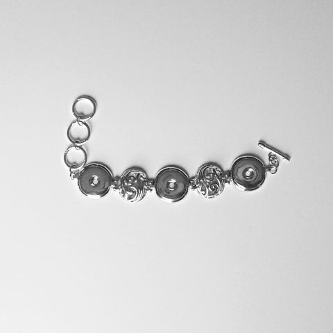 Silver coloured bracelet with hollow round filigret circles for three  18 mm snaps