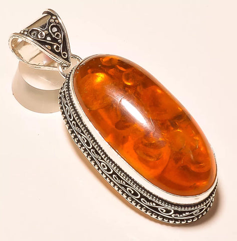 Carved In Amber Pendant